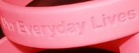 Close up picture of wristband show "Our Everyday Lives" in English.
